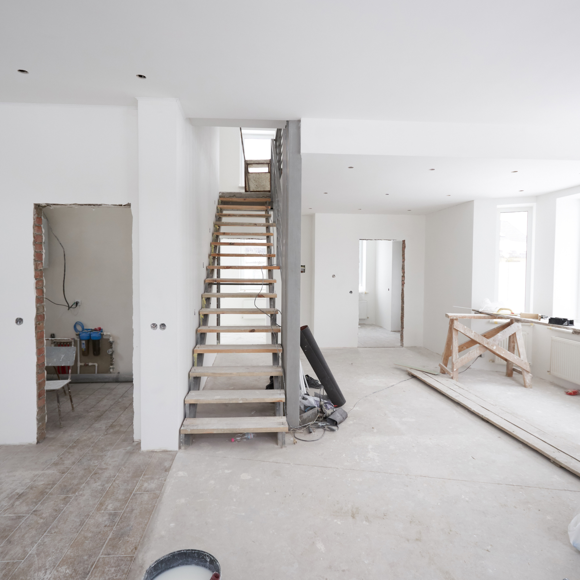 Modern interior renovation featuring updated flooring, staircase improvements, and an open-concept living space.